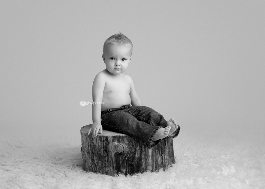 baby sitting on wooden stump