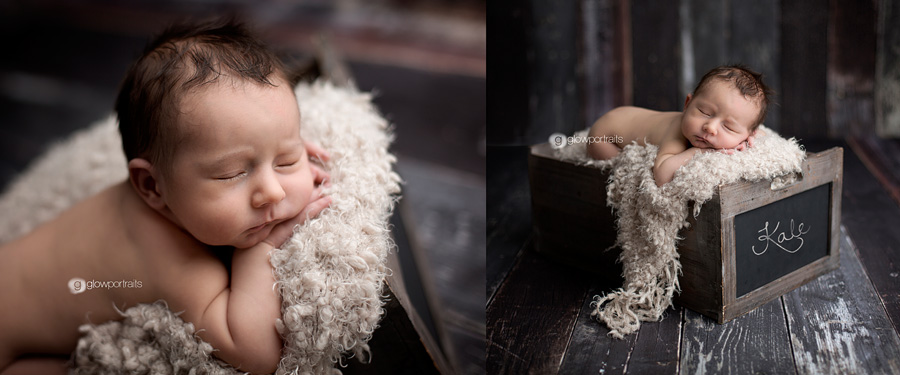 baby boy in box with name in chalk