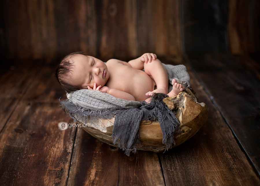 baby in wooden bowl